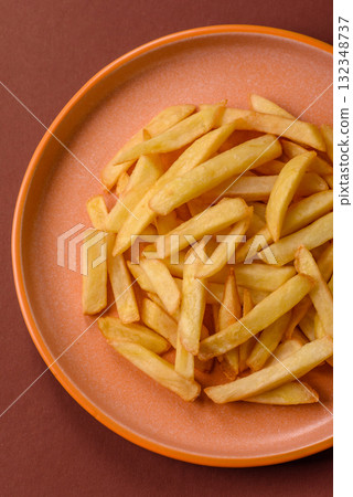 French fries, chips or snack with sauce as food background. French fries 132348737