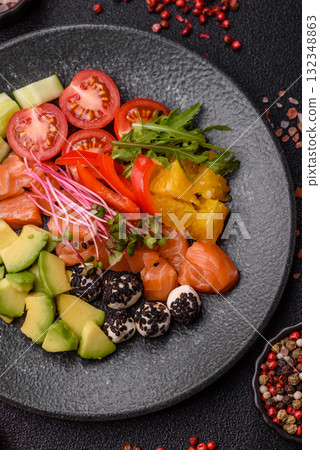 Bowl with salmon pieces, cheese, tomatoes, peppers and avocado. Salmon bowl 132348863