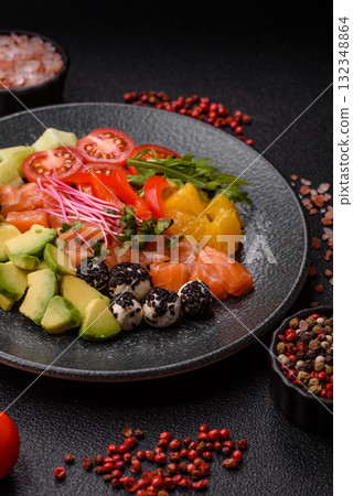 Bowl with salmon pieces, cheese, tomatoes, peppers and avocado. Salmon bowl 132348864
