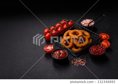 Onion rings or fried squid in breadcrumbs with sauce, takeaway food. Onion rings fried Onion rings or fried squid in breadcrumbs with sauce, takeaway food. Onion rings fried 132348893