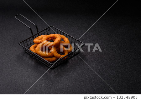 Onion rings or fried squid in breadcrumbs with sauce, takeaway food. Onion rings fried 132348903