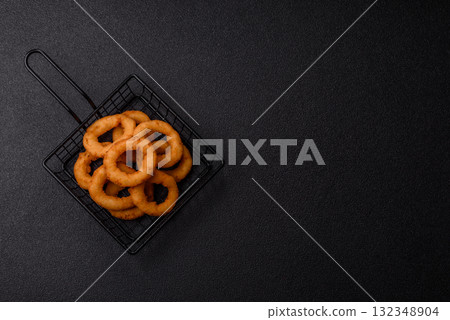 Onion rings or fried squid in breadcrumbs with sauce, takeaway food. Onion rings fried Onion rings or fried squid in breadcrumbs with sauce, takeaway food. Onion rings fried 132348904