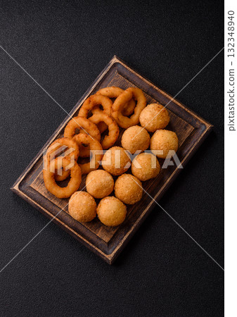 Fast food, cheese balls, onion or squid rings and French fries. Junk food as a background Fast food, cheese balls, onion or squid rings and French fries. Junk food as a background 132348940
