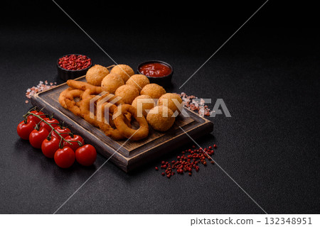 Fast food, cheese balls, onion or squid rings and French fries. Junk food as a background Fast food, cheese balls, onion or squid rings and French fries. Junk food as a background 132348951