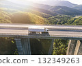 trucks on highway in mountain at sunset  132349263