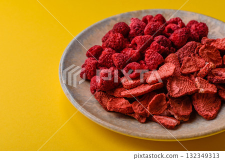 Dried sublimated slices of strawberry and raspberry as an ingredient for desserts. Dried strawberry 132349313