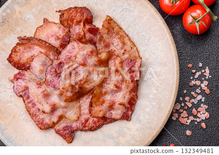 Cooked crispy fried pork bacon strips for a hearty breakfast. Fried bacon strips 132349481