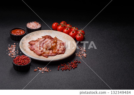 Cooked crispy fried pork bacon strips for a hearty breakfast. Fried bacon strips Cooked crispy fried pork bacon strips for a hearty breakfast. Fried bacon strips 132349484
