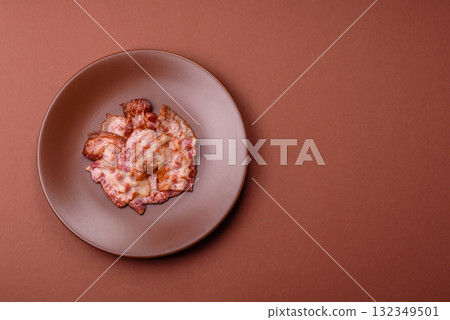 Cooked crispy fried pork bacon strips for a hearty breakfast. Fried bacon strips 132349501