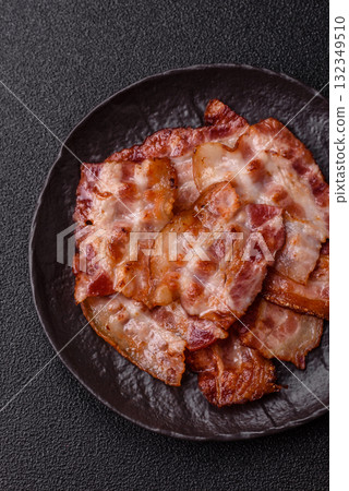 Cooked crispy fried pork bacon strips for a hearty breakfast. Fried bacon strips 132349510