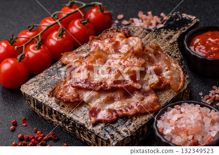 Cooked crispy fried pork bacon strips for a hearty breakfast. Fried bacon strips Cooked crispy fried pork bacon strips for a hearty breakfast. Fried bacon strips 132349523