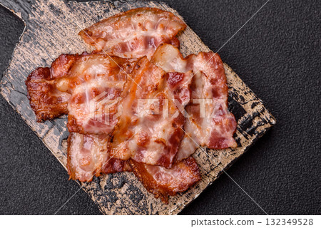 Cooked crispy fried pork bacon strips for a hearty breakfast. Fried bacon strips 132349528