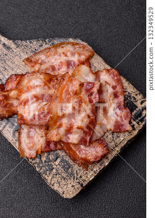 Cooked crispy fried pork bacon strips for a hearty breakfast. Fried bacon strips 132349529