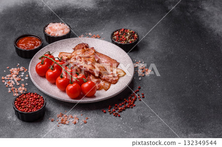 Cooked crispy fried pork bacon strips for a hearty breakfast. Fried bacon strips 132349544