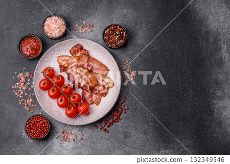 Cooked crispy fried pork bacon strips for a hearty breakfast. Fried bacon strips 132349546