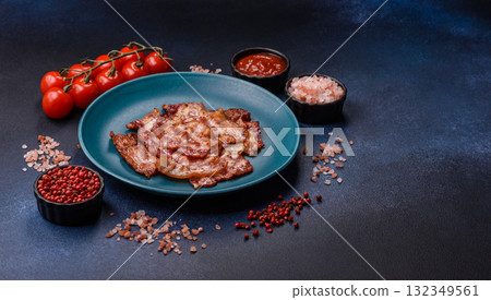 Cooked crispy fried pork bacon strips for a hearty breakfast. Fried bacon strips 132349561