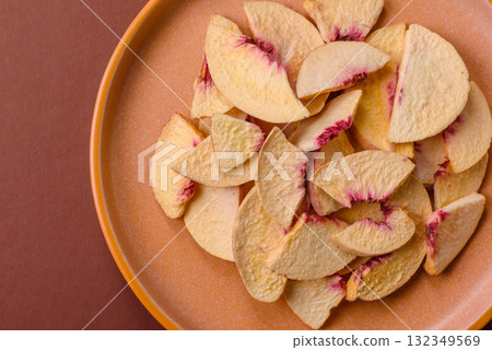 Dried sublimated slices of peach or apricot as an ingredient for sweet desserts. Dried peach Dried sublimated slices of peach or apricot as an ingredient for sweet desserts. Dried peach 132349569