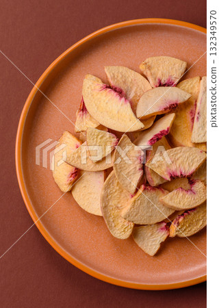 Dried sublimated slices of peach or apricot as an ingredient for sweet desserts. Dried peach 132349570
