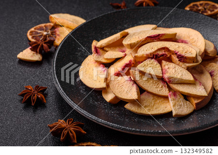 Dried sublimated slices of peach or apricot as an ingredient for sweet desserts. Dried peach Dried sublimated slices of peach or apricot as an ingredient for sweet desserts. Dried peach 132349582
