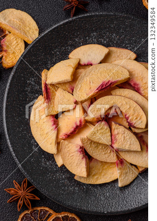 Dried sublimated slices of peach or apricot as an ingredient for sweet desserts. Dried peach Dried sublimated slices of peach or apricot as an ingredient for sweet desserts. Dried peach 132349584