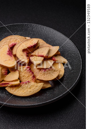 Dried sublimated slices of peach or apricot as an ingredient for sweet desserts. Dried peach 132349589