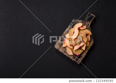 Dried sublimated slices of peach or apricot as an ingredient for sweet desserts. Dried peach Dried sublimated slices of peach or apricot as an ingredient for sweet desserts. Dried peach 132349595