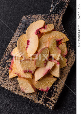 Dried sublimated slices of peach or apricot as an ingredient for sweet desserts. Dried peach 132349599