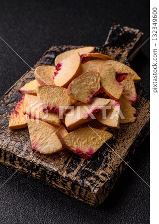 Dried sublimated slices of peach or apricot as an ingredient for sweet desserts. Dried peach Dried sublimated slices of peach or apricot as an ingredient for sweet desserts. Dried peach 132349600