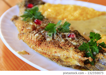 Trout fried with banusz and mushroom soup. Tasty dish Trout fried with banusz and mushroom soup. Tasty dish 132350073