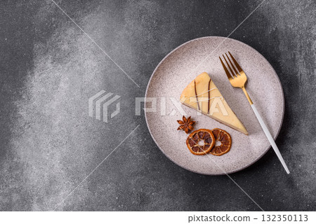 A piece of sweet New York cheesecake, dessert, cheese and vanilla pie. Classic cheesecake A piece of sweet New York cheesecake, dessert, cheese and vanilla pie. Classic cheesecake 132350113