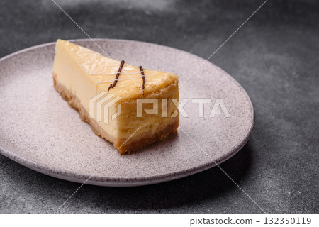 A piece of sweet New York cheesecake, dessert, cheese and vanilla pie. Classic cheesecake A piece of sweet New York cheesecake, dessert, cheese and vanilla pie. Classic cheesecake 132350119