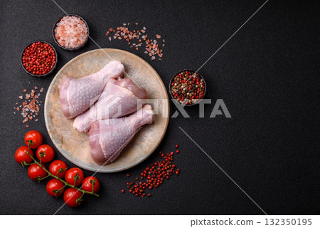 Raw chicken or turkey legs as a food background for cooking on a barbecue or grill. Chicken raw legs Raw chicken or turkey legs as a food background for cooking on a barbecue or grill. Chicken raw legs 132350195