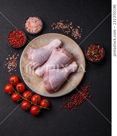 Raw chicken or turkey legs as a food background for cooking on a barbecue or grill. Chicken raw legs Raw chicken or turkey legs as a food background for cooking on a barbecue or grill. Chicken raw legs 132350196