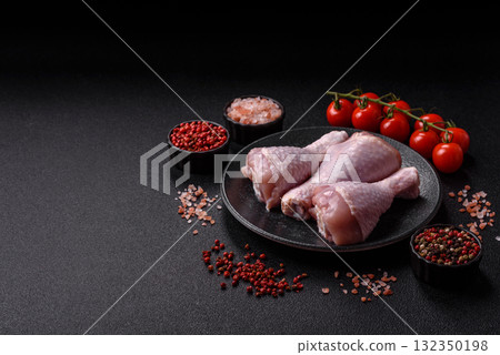 Raw chicken or turkey legs as a food background for cooking on a barbecue or grill. Chicken raw legs Raw chicken or turkey legs as a food background for cooking on a barbecue or grill. Chicken raw legs 132350198