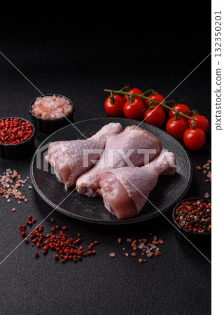 Raw chicken or turkey legs as a food background for cooking on a barbecue or grill. Chicken raw legs Raw chicken or turkey legs as a food background for cooking on a barbecue or grill. Chicken raw legs 132350201