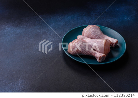 Raw chicken or turkey legs as a food background for cooking on a barbecue or grill. Chicken raw legs Raw chicken or turkey legs as a food background for cooking on a barbecue or grill. Chicken raw legs 132350214