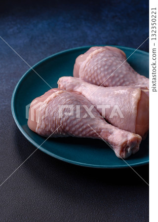 Raw chicken or turkey legs as a food background for cooking on a barbecue or grill. Chicken raw legs Raw chicken or turkey legs as a food background for cooking on a barbecue or grill. Chicken raw legs 132350221