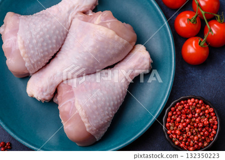 Raw chicken or turkey legs as a food background for cooking on a barbecue or grill. Chicken raw legs Raw chicken or turkey legs as a food background for cooking on a barbecue or grill. Chicken raw legs 132350223