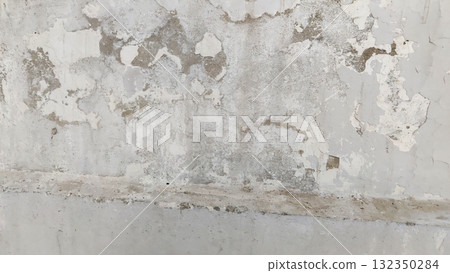 Peeling paint and stains on white wall due to water seepage damage 132350284