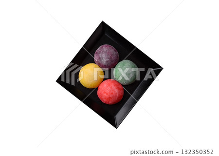 Japanese mochi, ice cream or Asian sweets with fruit filling. Mochi of different colors 132350352