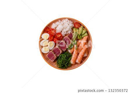 Seafood bowl, tuna tataki fillet slices with rice, oranges, tomatoes and sauce. Tuna bowl 132350372