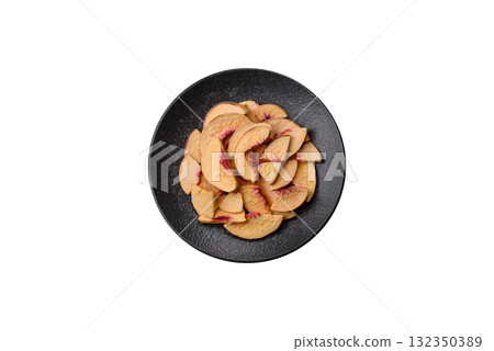 Dried sublimated slices of peach or apricot as an ingredient for sweet desserts. Dried peach Dried sublimated slices of peach or apricot as an ingredient for sweet desserts. Dried peach 132350389
