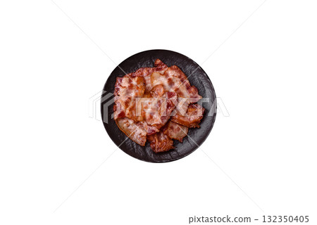 Cooked crispy fried pork bacon strips for a hearty breakfast. Fried bacon strips 132350405