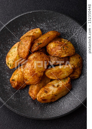 Potato wedges baked with spices, garlic and rosemary. Potato wedges Potato wedges baked with spices, garlic and rosemary. Potato wedges 132350448