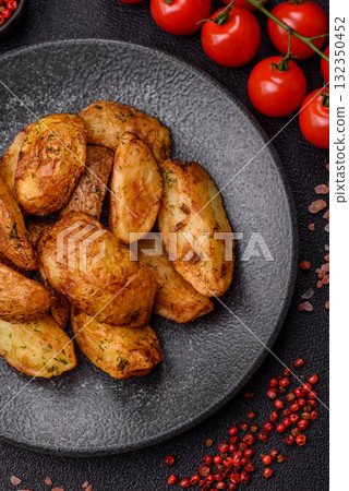 Potato wedges baked with spices, garlic and rosemary. Potato wedges 132350452