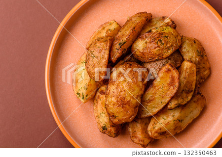 Potato wedges baked with spices, garlic and rosemary. Potato wedges Potato wedges baked with spices, garlic and rosemary. Potato wedges 132350463