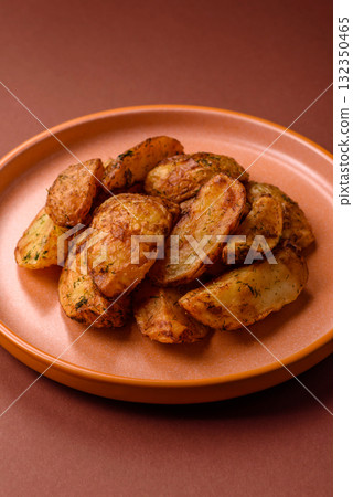 Potato wedges baked with spices, garlic and rosemary. Potato wedges Potato wedges baked with spices, garlic and rosemary. Potato wedges 132350465