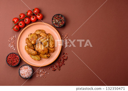 Potato wedges baked with spices, garlic and rosemary. Potato wedges Potato wedges baked with spices, garlic and rosemary. Potato wedges 132350471