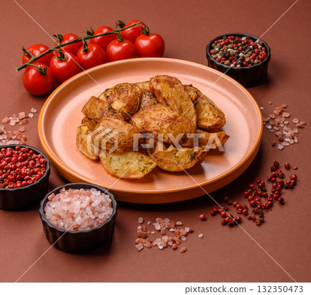 Potato wedges baked with spices, garlic and rosemary. Potato wedges Potato wedges baked with spices, garlic and rosemary. Potato wedges 132350473