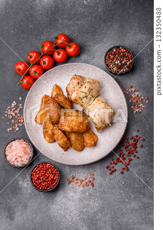 Potato wedges baked with spices, garlic and rosemary. Potato wedges 132350488